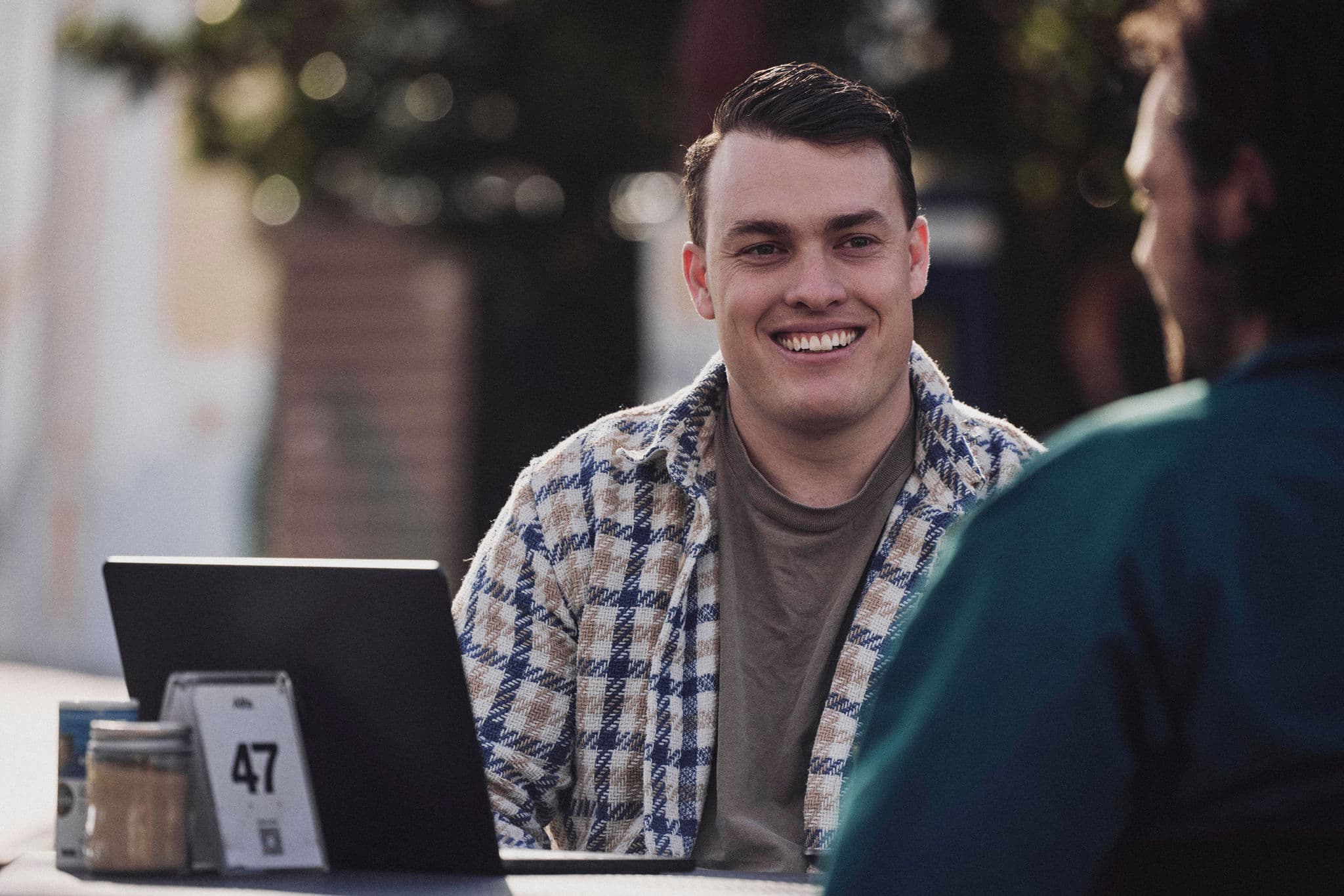 Jacob Williams smiling during a conversation with a client